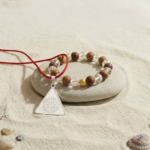 Shri Surya Yantra Silver Locket and Wood & Clear Crystal Bracelet Combo Front